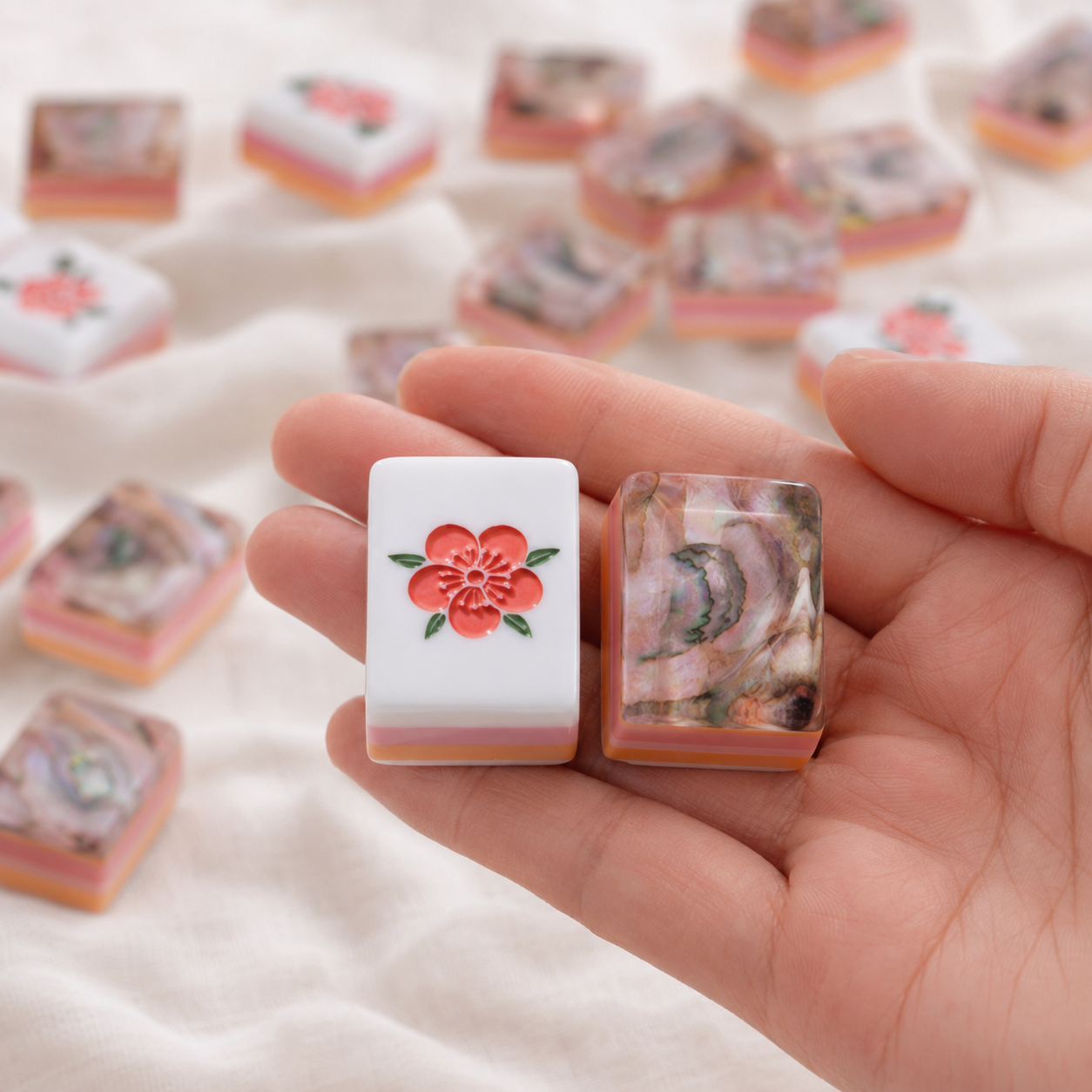 Close-up of floral face and abalone-inspired back on Mahjong tiles