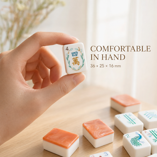 Coral orange American mahjong tile held in hand, measuring 36 by 25 by 16 millimeters