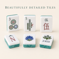 Turquoise-backed American mahjong tiles with lotus flowers, jokers, winds and classic suits